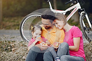 Family with a bicycle in a summer park