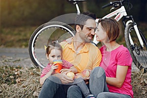 Family with a bicycle in a summer park