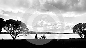 Family with bicycles walk slowly past the coast, a relaxed atmosphere