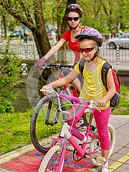 Family bike ride. Family wearing bicycle helmet with rucksack .