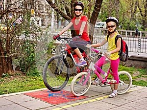 Family bike ride. Family wearing bicycle helmet with rucksack.