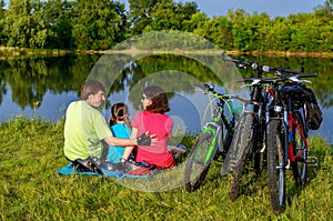 Family bike ride outdoors, active parents and kid cycling