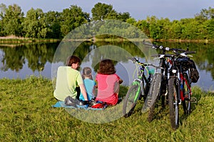 Family bike ride outdoors, active parents and kid cycling