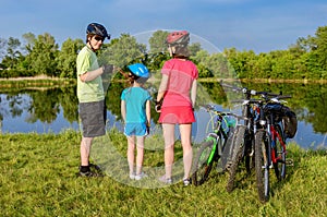 Family bike ride outdoors, active parents and kid cycling