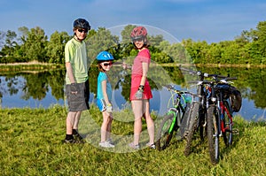 Family bike ride outdoors, active parents and kid cycling