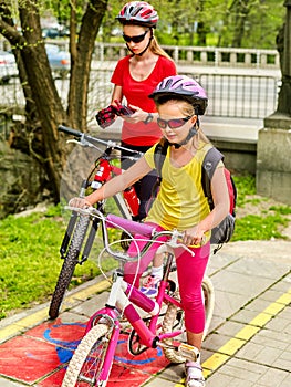 Family bike ride with rucksack cycling on bike lane.