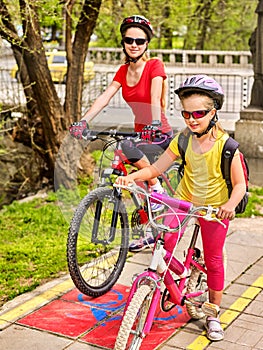 Family bike ride with rucksack cycling on bike lane.