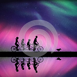 Family on bike tandem in park at night