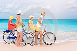 Family with a bike on tropical beach