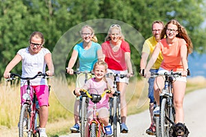 Family on bikes at dirt path