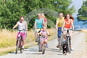 Family on bikes at dirt path