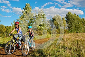 Family on bikes outdoors, active mother and kid cycling, fitness and healthy lifestyle