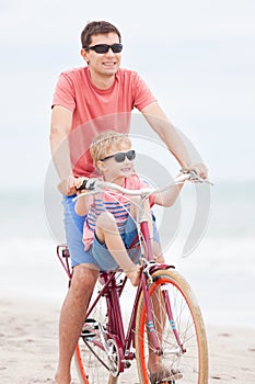 Family biking at the beach