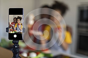 Family Blog. Black Father And Preteen Daughter Capturing Video In Kitchen