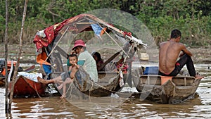 Family in boats, Tonle Sap, Cambodia