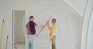 Family bonding during a DIY home renovation project. Father and his young son engaged in home renovation. The family is