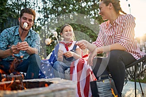 Family Bonfire Night with the American Flag and Marshmallows