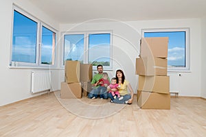 Family with boxes in new home