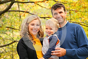 Family with boy in autumn park