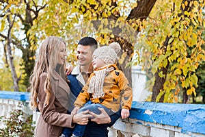 A family with a boy walking in the autumn Park happiness