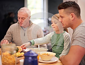 Family, breakfast and kid eating food in home together for bonding with father in the morning. Cereal, parents and