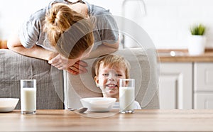 Family breakfast. mother feeding child son