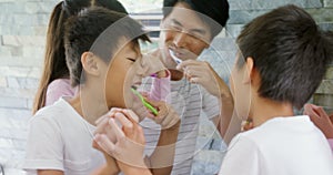 Family brushing teeth together in the bathroom 4k