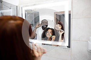 Family brushing their teeth while doing hygienic procedures