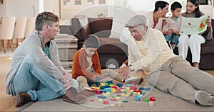 Family, building blocks with a grandfather, dad a son in the playing together living room of a home during a visit. Kids