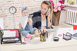 Family Business - telecommute Businesswoman and mother with kid is making a phone call