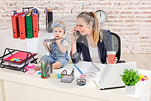 Family Business - telecommute Businesswoman and mother with kid is making a phone call