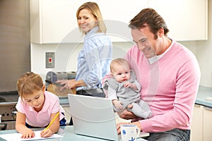 Family busy together in kitchen