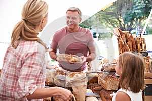 Family Buying Bread From Bakery Stall At Farmers Market