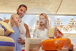 Family buying cheese at the outdoor market