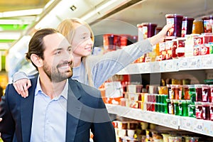 Family buying dessert in hypermarket