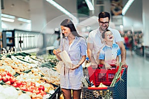 Family buying fruit at grocery store or supermarket - shopping, food, sale, consumerism