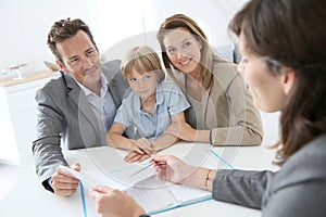 Family buying new house in real-estate agency