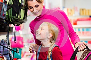 Family buying school satchel or bag in store