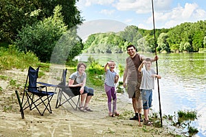 Family camping and fishing, people active in nature, child caugh