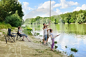 Family camping and fishing, people active in nature, child caugh