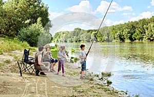 Family camping and fishing, people active in nature, child caugh