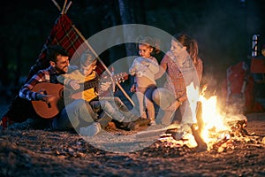 Family camping in the woods; Quality family time concept