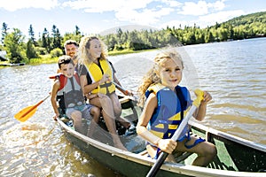 Family in a Canoe on a Lake having fun