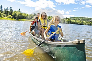 Family in a Canoe on a Lake having fun