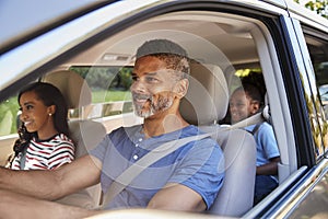 Family In Car Going On Road Trip