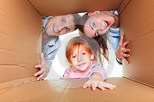 Family in a cardboard box ready for moving house