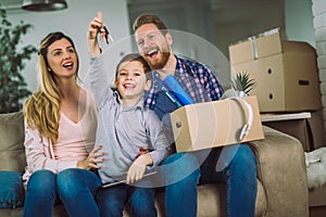 Family with cardboard boxes in new house at moving day