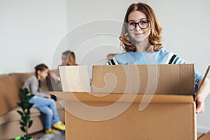 Family with cardboard boxes in new house at moving day