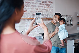 Family, care and mother with phone for photo of father and baby with down syndrome in the living room of their house