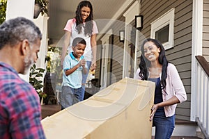 Family Carrying Big Box Purchase Into House